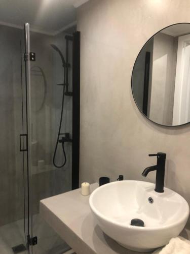 a bathroom with a white sink and a shower at Exarcheia House in Athens