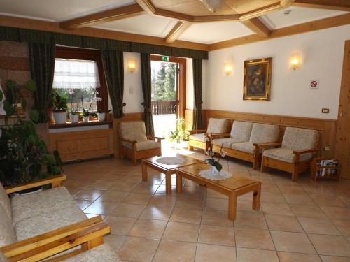 a large living room with couches and a table at Casa Santa Maria in Folgaria
