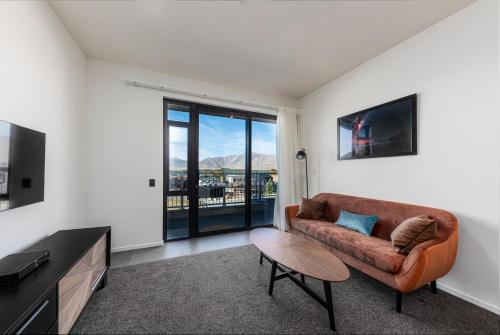 a living room with a couch and a table at Galaxy Boutique Hotel in Lake Tekapo
