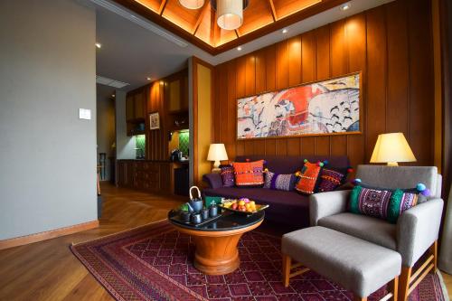 a living room with a couch and a table at Chala Number6 in Chiang Mai