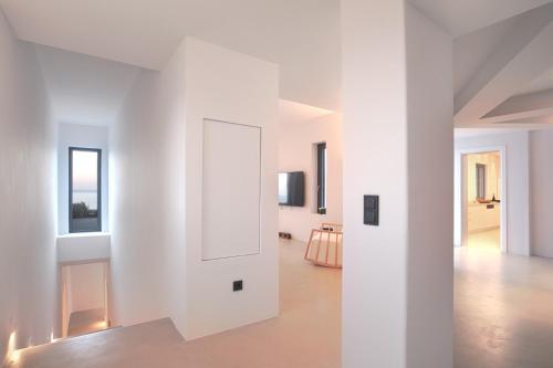 a white room with white walls and a white door at Villa Aqua Marine in Kalafatis