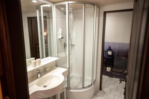 a bathroom with a sink and a shower at Altstadt Hotel Stadtkrug in Salzburg
