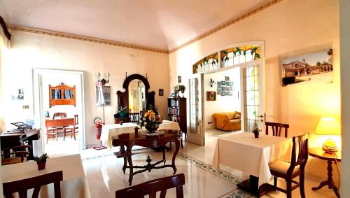 ein Wohnzimmer mit einem Tisch und einem Esszimmer in der Unterkunft Hotel Casa Mia in Syrakus