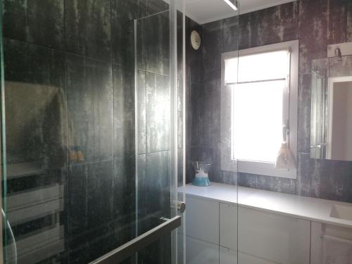 a bathroom with a glass shower and a window at Chambre double avec salle de bain commune, a 2 min de la Croisette in Cannes