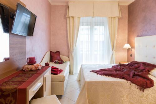 Postel nebo postele na pokoji v ubytování Hotel Petronio