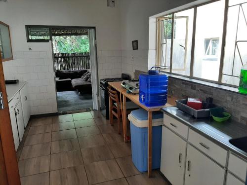 a kitchen with a table and a counter top at Elephant Walk Guesthouse and Back Packers in Phalaborwa