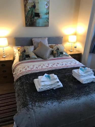 a bedroom with a bed with towels on it at The Rose Luxury Self Catering Accommodation in Armagh