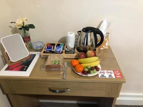 a wooden table with a bowl of fruit on it at The Rose Luxury Self Catering Accommodation in Armagh