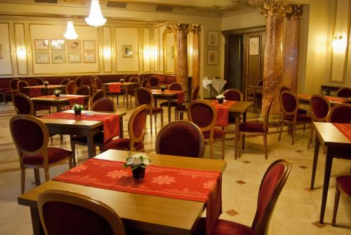 a restaurant with tables and chairs in a room at Hotel Casa Capsa in Bucharest