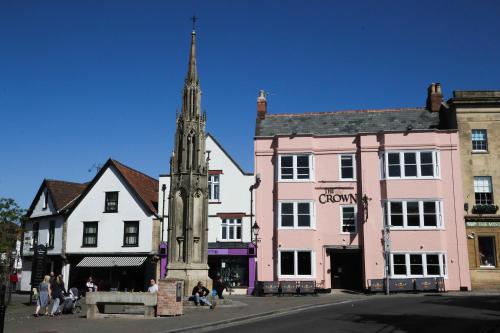 a street in a town with a church tower at The Crown Hotel in Glastonbury