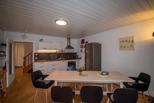 a kitchen with a table and chairs in a room at Ferienwohnung Altes Forsthaus Hella in Grebenhain