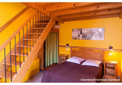 a bedroom with two beds and a staircase with yellow walls at Hôtel La Garenne in Labeaume