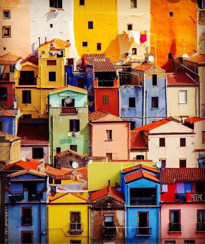 a view of a bunch of buildings with roofs at Regnos Altos boutique rooms in Bosa