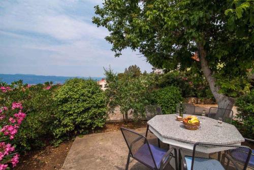 a table with a bowl of fruit on top of it at Apartment Vrbnik 7 in Vrbnik