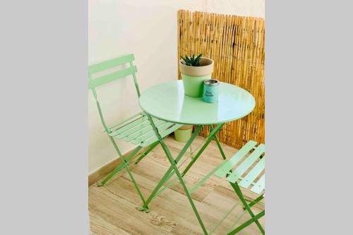 una mesa verde, una silla y una planta en Roof Top Luxury City Center Apartment, en Torremolinos