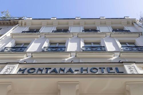 a sign on the facade of a hotel at Hotel Louvre Montana in Paris