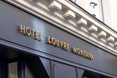 a hotel sign on the side of a building at Hotel Louvre Montana in Paris