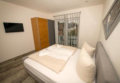 a bedroom with a white bed and a couch at FBA Village in Bundenthal