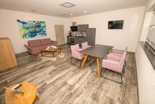 a living room with a table and chairs and a couch at FBA Village in Bundenthal