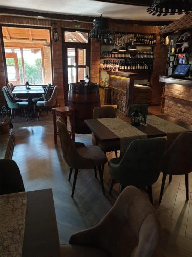 a restaurant with tables and chairs and a bar at Etno kuca sa konacistem GOCKO in Vrnjačka Banja