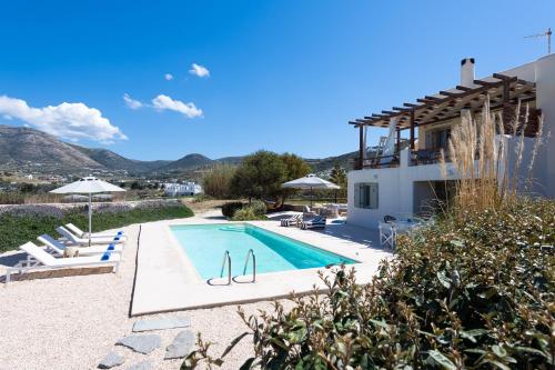 a villa with a swimming pool and a house at Parasporos Villa - Private Pool - Beach Access in Parasporos