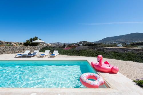 a swimming pool with a float and an inflatable at Parasporos Villa - Private Pool - Beach Access in Parasporos