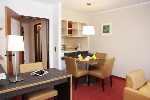 a dining room with a table and chairs at Hotel Gästehaus Forum am Westkreuz in Munich