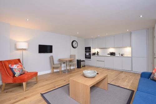 a living room with a blue couch and a table at Destiny Scotland New Town Apartments in Edinburgh