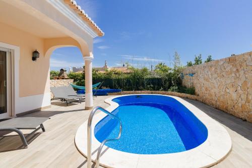 a villa with a swimming pool and a patio at Casa Vista Mar in Carvoeiro