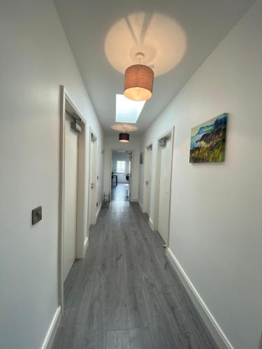 a hallway with white walls and a ceiling at Pier House Luxury Apartment in Dingle