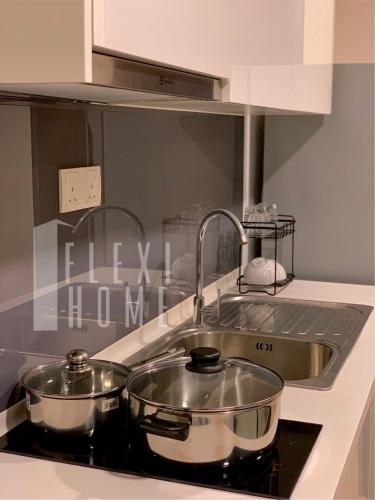 a kitchen counter with two pots and a sink at Spacious Big Room, Designed & Quiet Family Home, Eclipse in Cyberjaya by Flexihome-MY in Cyberjaya