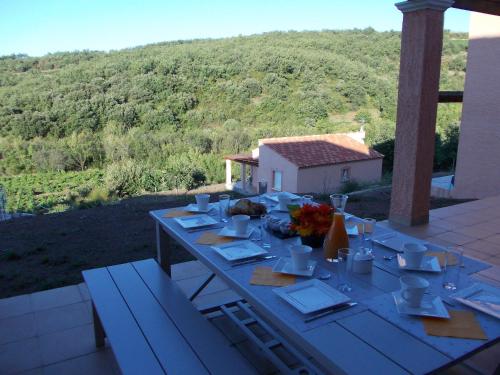 a table set up for a meal on a patio at Domaine de Flo ADULT a partir de 16 ans in Saint-Jean-de-la-Blaquière