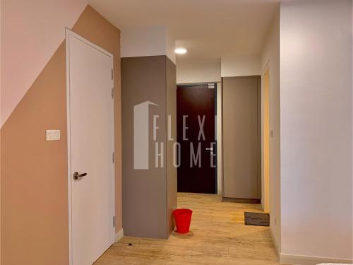 a hallway with a door and a red bucket at Spacious Big Room, Designed & Quiet Family Home, Eclipse in Cyberjaya by Flexihome-MY in Cyberjaya