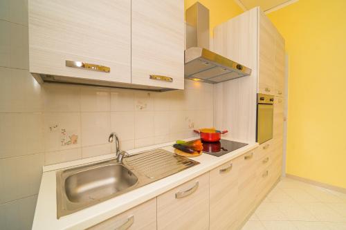 a kitchen with a sink and a counter top at Ada's House in Atrani