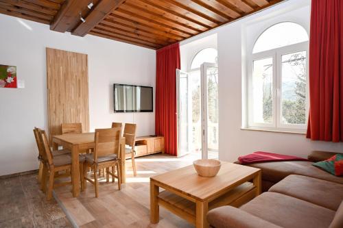 a living room with a couch and a table at Waldschlössl Schneedörfl in Reichenau