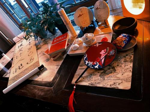 a table with chinese items on top of it at Suzhou Jade Snow Lodge in Suzhou