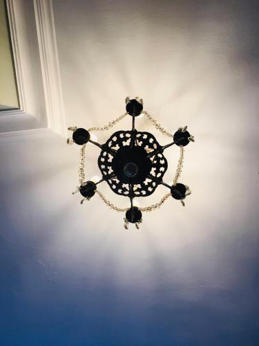 a chandelier hanging from a ceiling in a room at Lissanisky House in Ballymackey