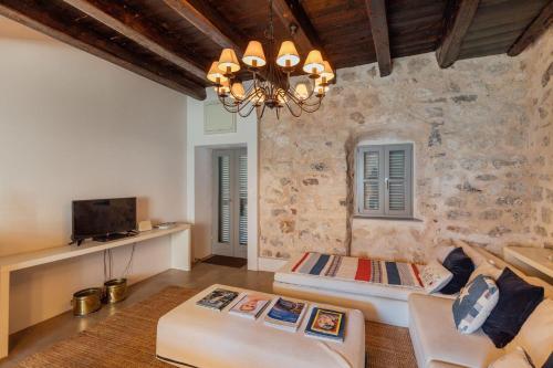 a living room with a couch and a chandelier at 18th Century Villa in the UNESCO Bay of Kotor in Kotor