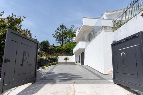 two doors with the letters a and q on them in front of a building at Prestige house 4 in Scalea