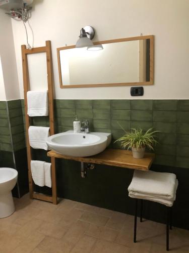 uma casa de banho com um lavatório e um espelho em Chicchi Di Melograno em Modica