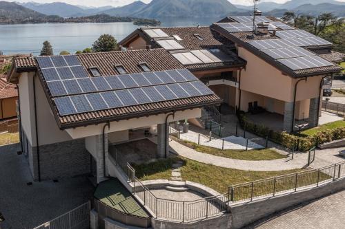 a group of houses with solar panels on the roofs at Baveno Hills | Lakeview apartments in Baveno