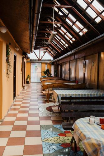 a room with tables and benches in a building at Vila Verona Sobe in Palić