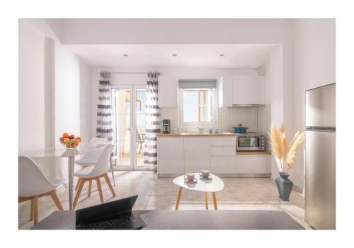 a kitchen and living room with a table and chairs at Kastri Mare Sea View Residences by Estia in Keratokampos