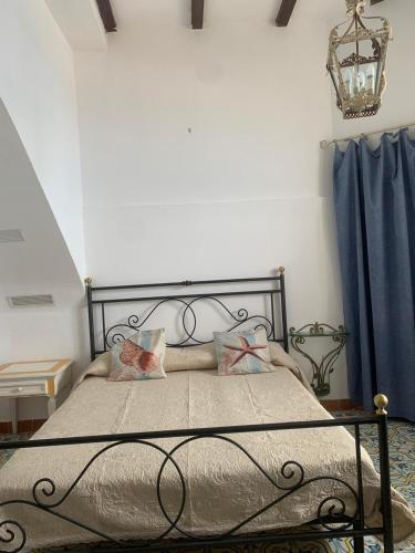 a bedroom with a metal bed with two pillows at Casa Barbara in Amalfi