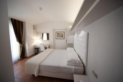 Cama o camas de una habitación en Albergo Rossini 1936