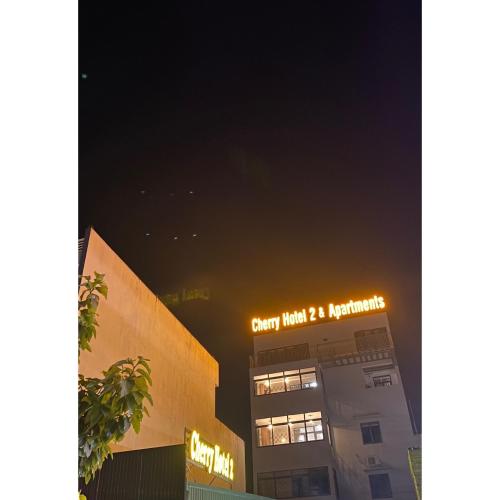 a building with a sign on top of it at night at Cherry Hotel Bến Lức in Bến Lức