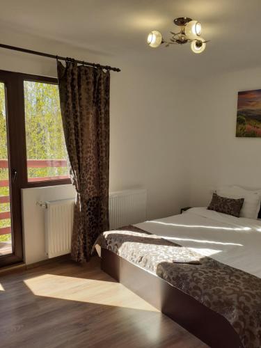 a bedroom with two beds and a window at Casa Moșoiu in Bran