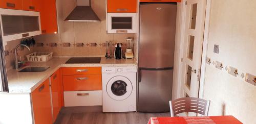 a kitchen with a refrigerator and a washing machine at Casa Jon Con Garage Y Wifi in Barakaldo