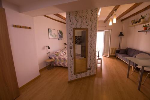 a living room with a mirror and a couch at MORELLA CENTRO Apartamento-Loft in Morella