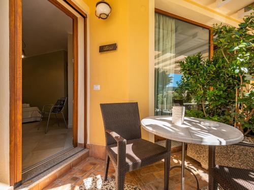 a patio with a table and chairs on a porch at B&B Giglio di Chia in Domus de Maria